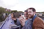 Couple taking selfie on canal boat