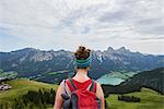 Rear view of female hiker looking out over valley in Tannheim mountains, Tyrol, Austria