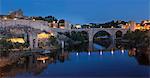 Puente de San Martin Bridge and San Juan des los Reyes Monastery reflected in the Tajo River, Toledo, Castilla-La Mancha, Spain, Europe