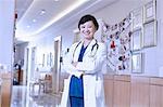 Portrait of doctor in hospital corridor looking at camera smiling