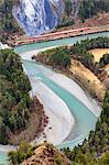 The Red Train travels along the Rhine River, Rhein Gorge (Ruinaulta), Flims, Imboden, Graubunden, Switzerland, Europe