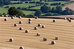 Round hay bales and Cotswold farmland at Wadfield farm, Winchcombe, Cotswolds, Gloucestershire, England, United Kingdom, Europe