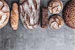 Delicious freshly baked brown bread on wooden background