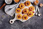 Freshly baked pumpkin muffins and ingredients for baking. Top view