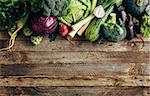 Fresh organic raw vegetables on a wooden table,top view. Healthy food background wiht copyspace.
