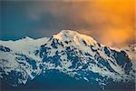 Beautiful sunset over the snowy mountain peak. Nature landscape scene. Travel background. Holiday, travel, sport, recreation. Main Caucasian ridge, Svaneti, Georgia. Retro toning filter