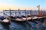 Gondolas covered in snow with view to La Guidecca, sunrise, Venice, UNESCO World Heritage Site, Veneto, Italy, Europe