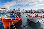 Colourful boats in harbour, whitewashed Mykonos Town (Chora) with windmills and churches, Mykonos, Cyclades, Greek Islands, Greece, Europe