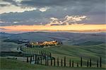 Dusk on green hills surrounded by cypresses and farm houses, Crete Senesi (Senese Clays), province of Siena, Tuscany, Italy, Europe