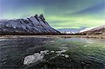 The snowy peak of Otertinden and the Northern Lights in the polar night, Oteren, Lyngen Alps, Troms, Norway, Scandinavia, Europe