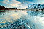 Sunset on the frozen Lej Nair surrounded by snowy peaks, Bernina Pass, Canton of Graubunden, Engadine, Switzerland, Europe