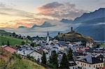 Misty sky on the alpine village of Ardez at sunrise, district of Inn, Lower Engadine, Canton of Graubunden, Switzerland, Europe