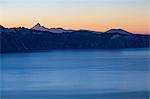 Dusk over the still waters of Crater Lake, the deepest lake in the U.S.A., with Mount Thielsen, part of the Cascade Range, Oregon, United States of America, North America