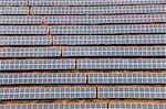 Aerial view of long rows of solar panels in the desert.