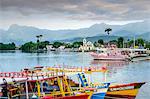 Fishing boats in Paraty village with the mountains of the Serra da Bocaina behind, Rio de Janeiro state, Brazil, South America