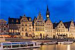 Belfry, houses and boats on Lys canal, Ghent, East Flanders province, Flemish region, Belgium, Europe