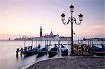 View towards San Giorgio Maggiore at dawn from Riva Degli Schiavoni, with gondolas in foreground, Venice, UNESCO World Heritage Site, Veneto, Italy, Europe