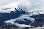 Tongue of the Vatnajokull Glacier creeping down the mountains behinf Fjallsarlon lagoon, South Iceland, Polar Regions