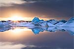 Icebergs covered in dusting of snow in winter at sunset, Jokulsarlon Glacial Lagoon, South Iceland, Polar Regions