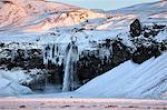 Winter view of Seljalandsfoss Waterfall bathed in evening light, South Iceland, Polar Regions