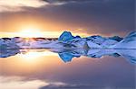 Icebergs covered in dusting of snow, winter, sunset, Jokulsarlon Glacial Lagoon, South Iceland, Polar Regions