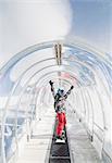 Portrait of snowboarder in ski run tunnel, on moving walkway