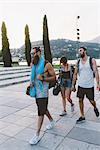 Three young hipster friends strolling on waterfront, Lake Como, Lombardy, Italy