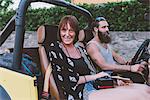 Portrait of young couple on road trip in off road vehicle, Como, Lombardy, Italy