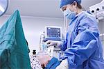 Anaesthetist monitoring patient in maternity ward operating theatre