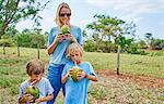 Family drinking through straws from coconut, Bonito, Mato Grosso do Sul, Brazil, South America