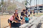 Schoolgirl soccer team preparing at school sports field