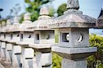 Close op of sculptural stone pillars, Japanese shinto shrine.