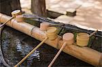 Close up of bamboo water hand washing basins at Shinto Sakurai Shrine, Fukuoka, Japan.