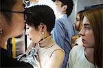 Small group of people standing on a subway train, Tokyo commuters.