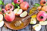 Apples, pomegranate and honey - symbols of judaic holiday Rosh Hashana (Jewish New Year). Selective focus.