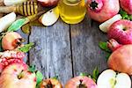 Apples, pomegranate and honey - symbols of judaic holiday Rosh Hashana (Jewish New Year). Selective focus. Copyspace background.