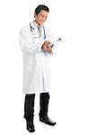 Full length attractive young male Southeast Asian medical doctor writing, standing isolated on white background.