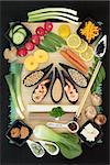 Macrobiotic food selection with seafood, tofu, udon and sobu noodles, miso paste, grains, legumes, fruit, vegetables and wasbai nuts with foods high in protein, antioxidants, fibe, vitamins and minerals, on bamboo, top view.