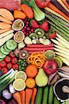 Large healthy food selection promoting good health with fresh vegetables and fruit forming an abstract background. Foods high in antioxidants, anthocyanins, minerals, vitamins and dietary fiber. Top view.