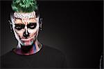 Portrait of man with mystical makeup. Face art concept, professional makeup for Halloween party.