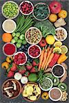Large health food collection with fruit, fish, vegetables with spices and herbs also used in natural herbal medicine. Superfoods concept with foods high anthocyanins, fiber, antioxidants and vitamins.