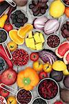 Super food health promoting food concept with fruit, vegetables, pulses and grains high in antioxidants, anthocyanins and vitamins on rustic wood background.