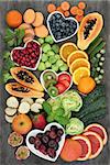 Super food for a high fiber diet with fresh fruit and vegetables, concept of foods high in smart carbohydrates, antioxidants and vitamins, on marble background, top view.