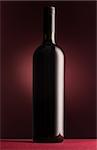Excellent unlabeled red wine bottle on red background