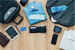How to pack for a business trip: all items that needs to be packed and a bag on a desktop, travel concept
