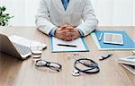 Professional doctor in his office working at desk, healthcare and hospitals concept