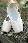 Pink pointe shoes for a classical ballerina, close-up on concrete