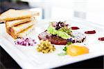 Classic steak tartare with raw egg and croutons