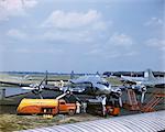 1950s CONSTELLATION PROPELLER COMMERCIAL PASSENGER AIRPLANE BEING SERVICED FOR FLIGHT TO ENGLAND LAGUARDIA AIRPORT NEW YORK USA