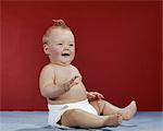 1960S BABY WEARING CLOTH DIAPER SITTING UP LAUGHING HAPPY